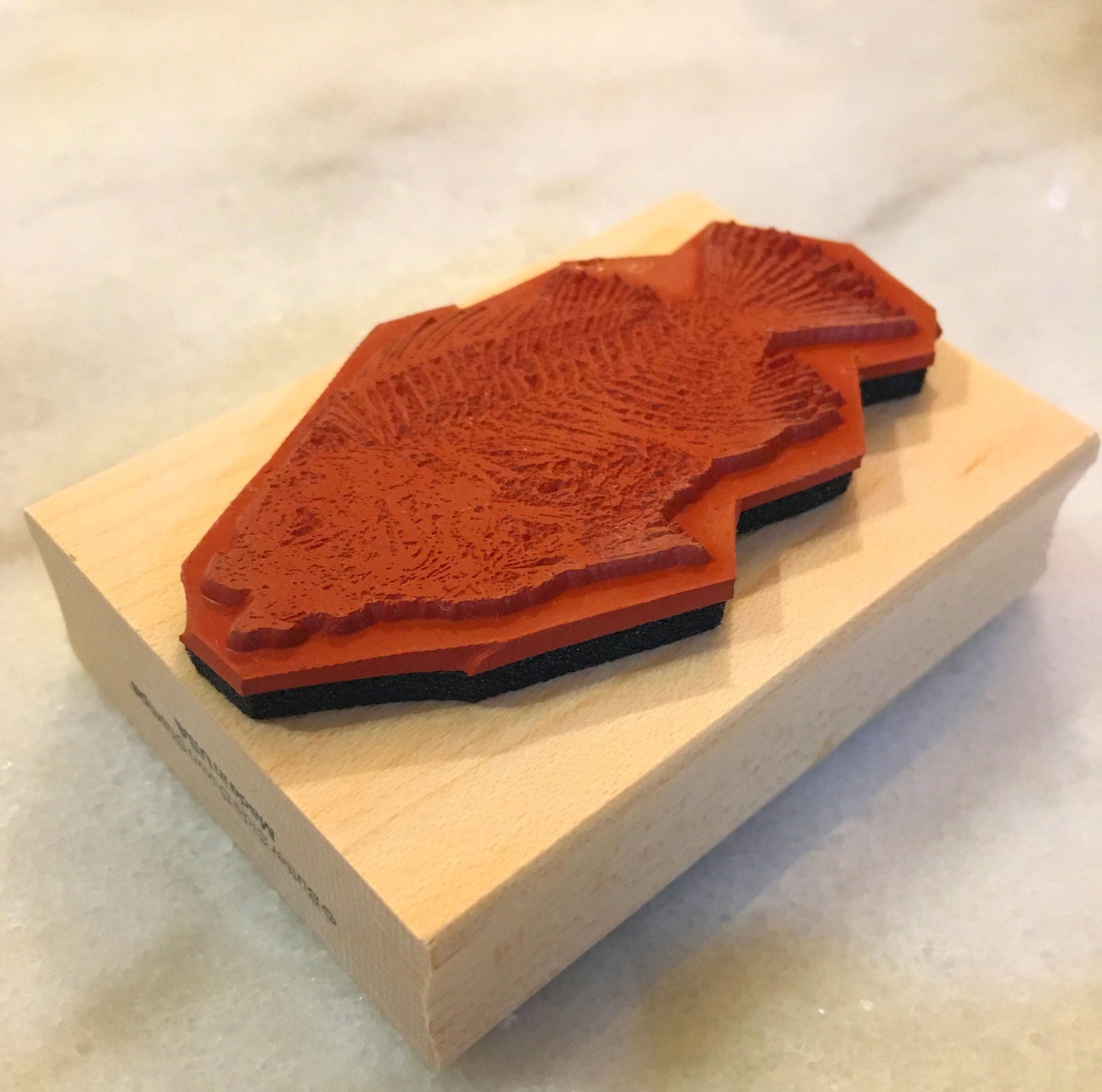 Priscacara fossil stamp deep etch relief side.
